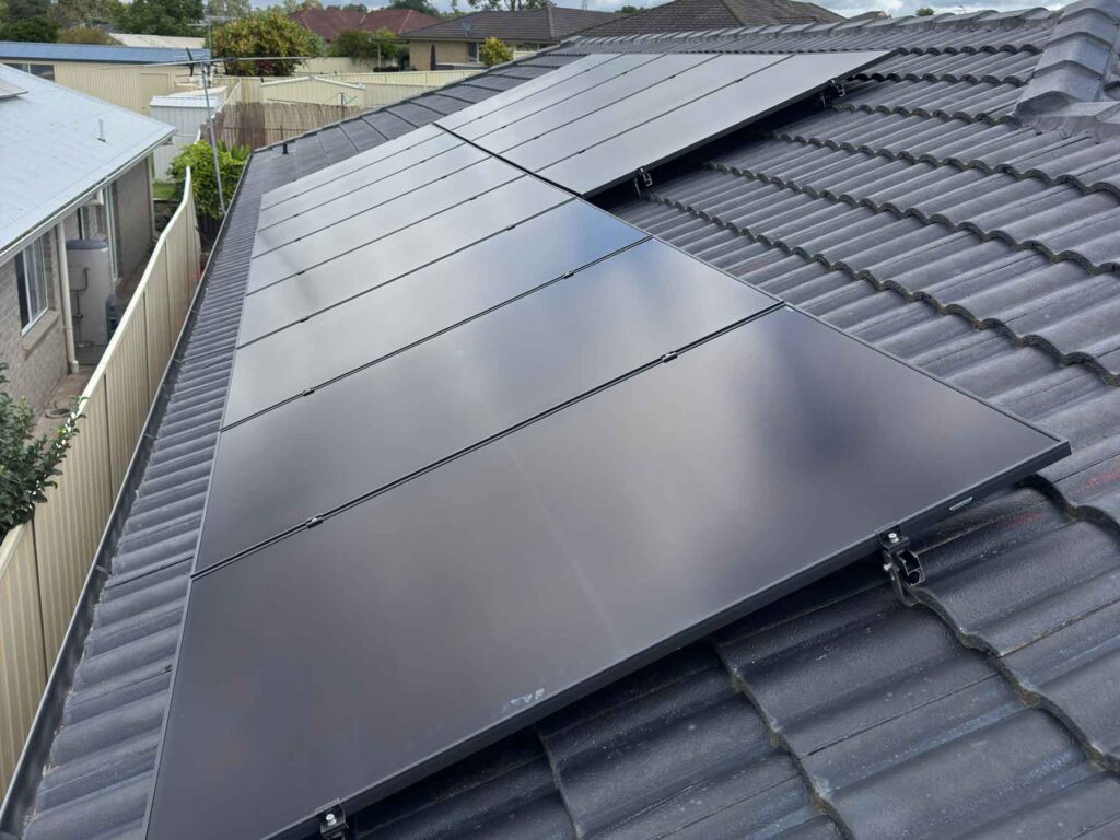 Sleek all-black solar panels installed on a tiled roof