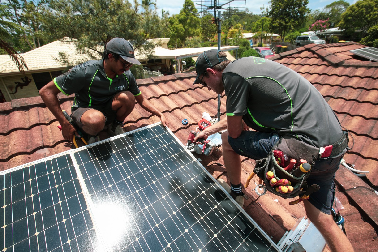 Renew Energy technicians installing solar panels on a roof